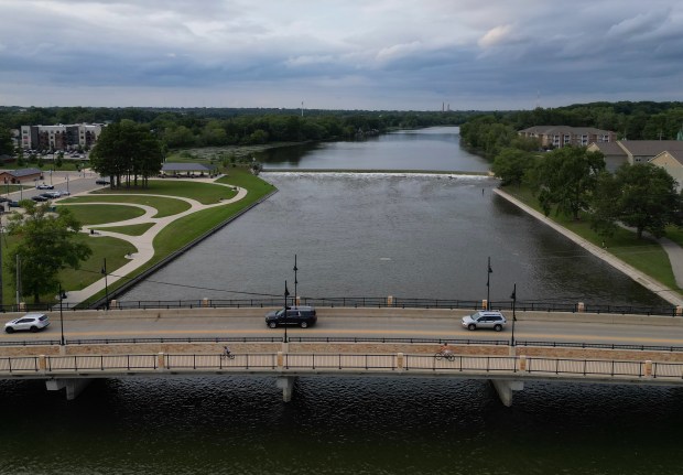 Cars and bicycles cross the State Street bridge over the Fox River south of the dam at Panton Mill Park on Aug. 8, 2024, in South Elgin. (Stacey Wescott/Chicago Tribune)