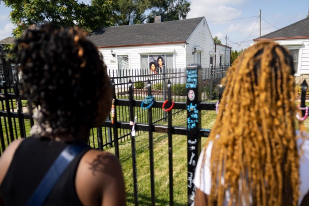 Ambria Lockett, left, and daughter Kameran Cooper, 16, right, from Gary, Indiana, celebrate Michael Jackson's birthday by spending time outside the Jackson Family Home in Gary on Aug. 29, 2024. (Tess Crowley/Chicago Tribune)