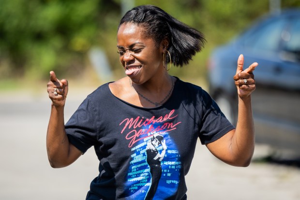 Sarah Ross, from Crown Point, Indiana, dances to Michael Jackson's music as she celebrates Michael Jackson's birthday outside the Jackson Family Home in Gary, Indiana on Aug. 29, 2024. Ross moved to Indiana in June from Texas and the Jackson Family Home was her first stop after her move. Her goal is to visit the home once a month while living in Indiana. (Tess Crowley/Chicago Tribune)