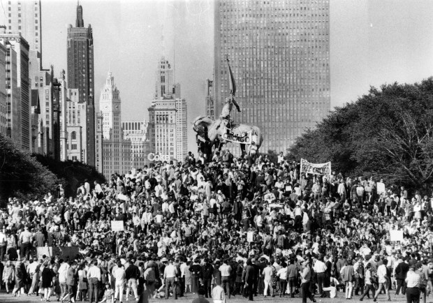 Demonstrators gather around the General Logan monument in Grant Park in 1968, to listen to speeches protesting police actions during the Democratic National Convention in Chicago. (John Austad/Chicago Tribune)