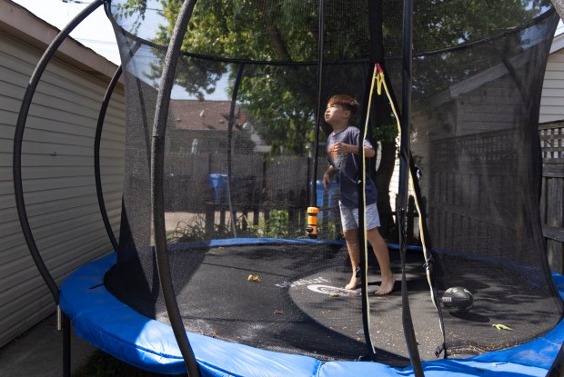 Laike Glesne, 7, jumps in his trampoline at home on Aug. 12, 2024, in Chicago. (Stacey Wescott/Chicago Tribune)