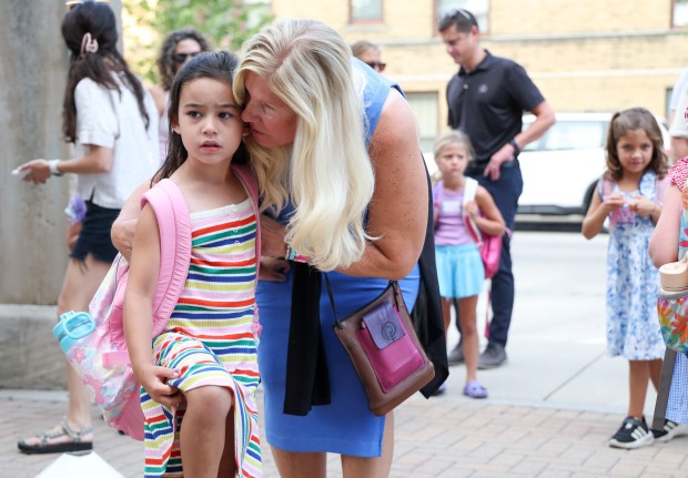 Suzanne Mak speaks to her daughter kindergartner Addie Mak on her first day of school at Hamilton Elementary School in Lake View Monday, Aug. 26, 2024. (Eileen T. Meslar/Chicago Tribune)