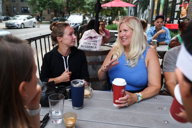 Suzanne Mak, right, visits with Laura Getting at Bitter Pops after dropping their children off for their first day of school at Hamilton Elementary School in Lake View on Monday, Aug. 26, 2024. (Eileen T. Meslar/Chicago Tribune)