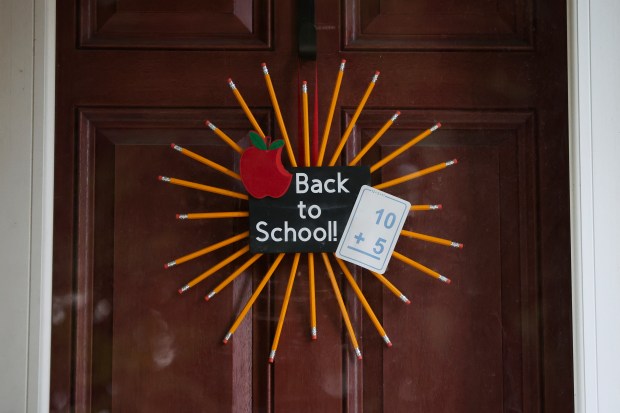 A decoration hangs on the door of the home of Magen Hanrahan in Lincoln Square Monday, Aug. 26, 2024, where she hosts her 7th Annual Muffins and Mimosas back-to-school party for parents of students at Chappell Elementary School. (Eileen T. Meslar/Chicago Tribune)