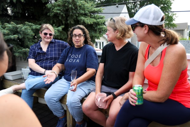 Melissa Casey, from left, Xiomara Padamsee, Kathleen Faber, and Megan Hagans, visit at the home of Magen Hanrahan in Lincoln Square Monday, Aug. 26, 2024, for the 7th Annual Muffins and Mimosas back-to-school party for parents of students at Chappell Elementary School. (Eileen T. Meslar/Chicago Tribune)