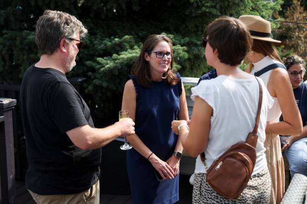 Magen Hanrahan, center, visits with other parents of students at Chappell Elementary School at her home in Lincoln Square Monday, Aug. 26, 2024, for her 7th Annual Muffins and Mimosas back-to-school party. (Eileen T. Meslar/Chicago Tribune)