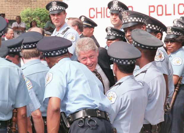 Then-President Bill Clinton, center, greets newly hired Chicago police officers on June 30, 1995, during an award ceremony for Clinton given by the Illinois Council Against Handgun Violence in Chicago. The officers were hired with federal funds from Clinton's Crime Bill. (Paul Richards/Getty-AFP)