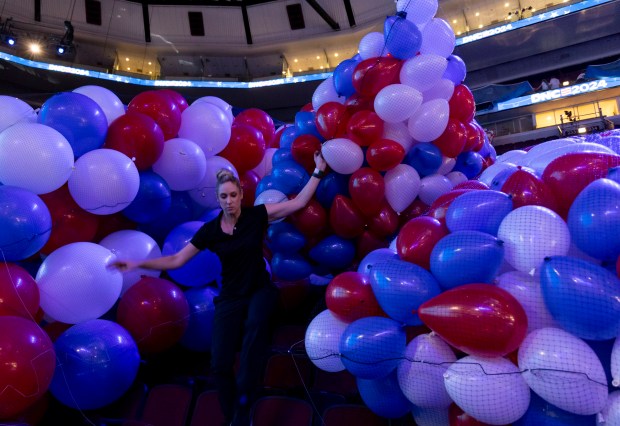 Red, white and blue balloons are bundled before being raised to the rafters on Aug. 15, 2024, inside the Democratic National Convention at the United Center. (Brian Cassella/Chicago Tribune)