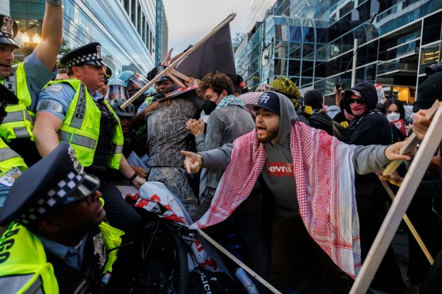 Activists scuffle with Chicago police outside the Israeli Consulate while protesting the war in Gaza during the second day of the Democratic National Convention, Aug. 20, 2024. (Armando L. Sanchez/Chicago Tribune)