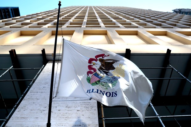 The Illinois state flag flaps in the wind on a downtown Chicago building on March 7, 2023. (Antonio Perez/Chicago Tribune)