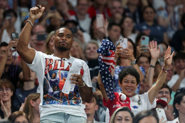 Jonathan Owens, a Bears safety and husband of Simone Biles, cheers her on alongside her mother, Nellie Biles, as the U.S. wins gold in the Olympic women's gymnastics team final July 30, 2024, at Bercy Arena in Paris. (Brian Cassella/Chicago Tribune)