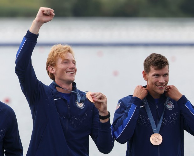 Nick Rusher waves to his family after getting his bronze medal alongside Henry Hollingsworth and the USA men's eight boat team in rowing Saturday, Aug. 3, 2024, at Vaines-sur-Marne Nautical Stadium during the Paris Olympics. (Brian Cassella/Chicago Tribune)