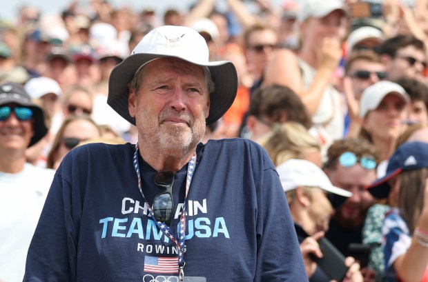 Chris Chatain watches his son, Peter Chatain, and the USA men's eight boat receive their bronze medals in rowing Saturday, Aug. 3, 2024, at Vaines-sur-Marne Nautical Stadium during the Paris Olympics. (Brian Cassella/Chicago Tribune)