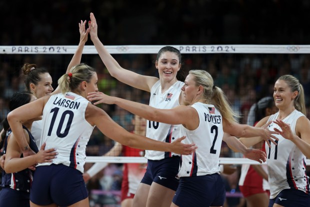 USA's Dana Rettke (center) and teammates celebrate a point as they defeat France 3-0 to advance to the volleyball quarterfinals, Aug. 4, 2024, at South Paris Arena 1 during the Paris Olympics. (Brian Cassella/Chicago Tribune)