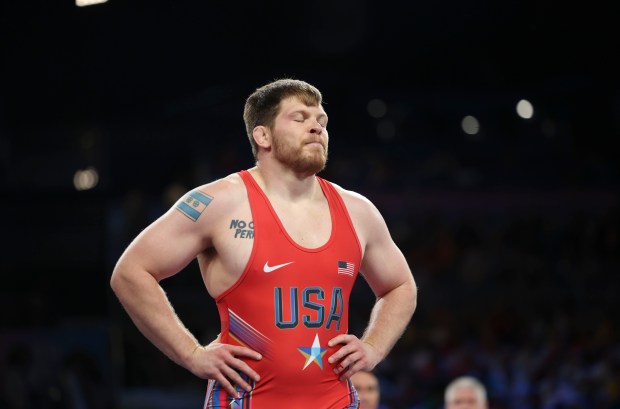 USA's Joe Rau, in red, regroups as he falls behind Kyrgyzstan's Uzur Dzhuzupbekov in a 97kg Greco-Roman wrestling match Wednesday, Aug. 7, 2024, at Champ de Mars Arena during the Paris Olympics. (Brian Cassella/Chicago Tribune)