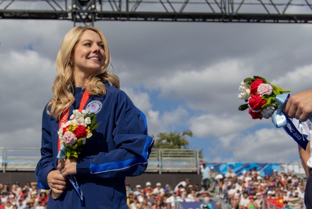 Alexa Knierim and her USA figure skating teammates finally receive their gold medals from the 2022 Beijing Winter Olympics on Aug. 7, 2024, at Champions Park in the Trocadero during the Paris Olympics. (Brian Cassella/Chicago Tribune)