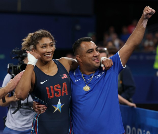 USA's Kennedy Blades and her coach, Izzy Martinez, celebrate after she defeated Kyrgyzstan's Aiperi Medet Kyzy 8-6 in an Olympic women's freestyle wrestling 76-kg semifinal, Aug. 10, 2024, at Champ-de-Mars Arena in Paris. (Brian Cassella/Chicago Tribune)