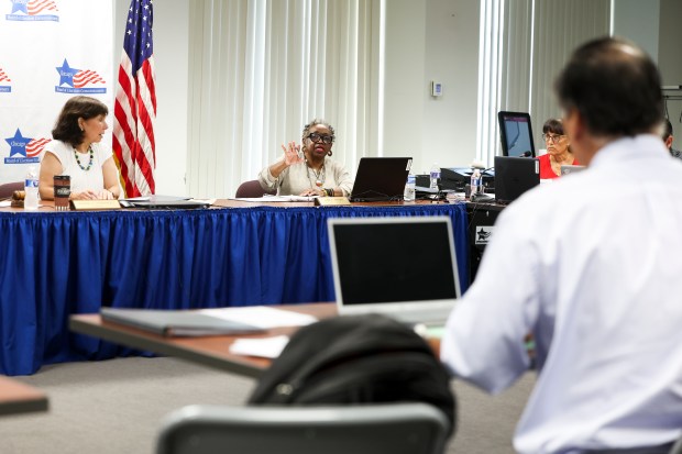 Chairwoman Marisel A. Hernandez and Commissioner June A. Brown hear a case against a candidate for school board elections during a Chicago Board of Election Commissioners meeting on Monday, Aug. 26, 2024. (Eileen T. Meslar/Chicago Tribune)