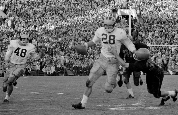 Michigan quarterback Bob Timberlake uses a straight-arm to slip away from an Oregon State defender in the Rose Bowl in Pasadena, Calif., on Jan. 1, 1965. (AP)