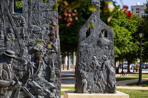 Sculptures commemorating the centennial of the Springfield race riot of 1908 outside the Abraham Lincoln Presidential Library and Museum in Springfield on Aug. 15, 2024. They represent charred chimneys rising from the smoldering rubble of burned-out buildings. (Tess Crowley/Chicago Tribune)