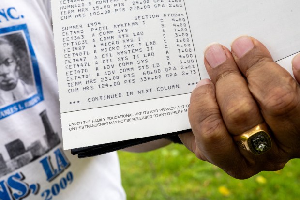 Marc Atkins, 66, holds his DeVry University transcript from the summer trimester in 1994 when he was enrolled in 23 credits while raising two kids and working full time. (Tess Crowley/Chicago Tribune)