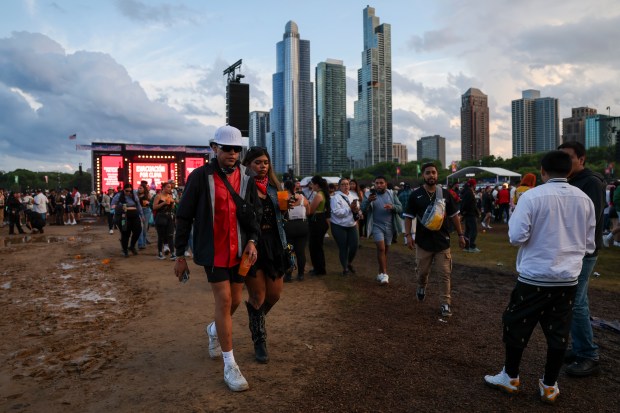 People attending the Sueños Festival exit Grant Park as the event was cut short due to inclement weather on May 26, 2024. (Eileen T. Meslar/Chicago Tribune)