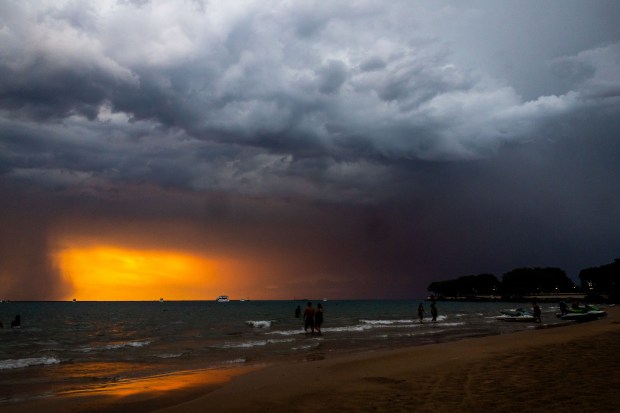 A storm rolls in at Ohio Street beach after a day of the heat index at triple digits on Aug. 27, 2024. (Tess Crowley/Chicago Tribune)