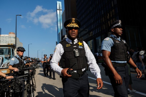 Superintendent Larry Snelling walks past officers while activists gather near North Michigan Avenue to protest the Democratic National Convention on Aug. 18, 2024, in Chicago. (Armando L. Sanchez/Chicago Tribune)