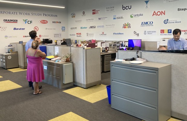 The Cristo Rey placement office is decorated with the names of numerous companies who employ students on the work study campus. (Steve Sadin/For the Lake County News-Sun)