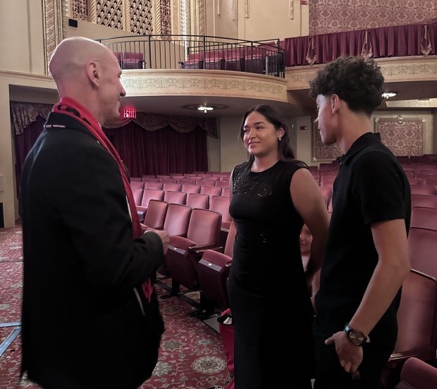 HOTC board president David Motley speaks with graduate athletes Adamariss Chavez and Grabriel Anguiano at the end of a gala that recognized players and was hosted at the Genesee Theatre in Waukegan on Aug. 10. (Yadira Sanchez Olson/For the Lake County News-Sun)