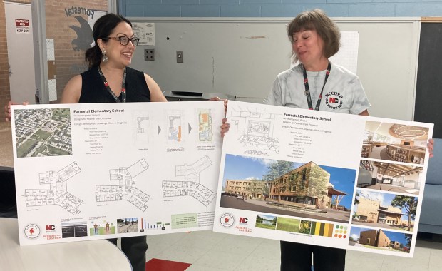 District 187 chief academic officer Ana Fuhrer, left, and Forrestal Elementary School Principal Cara Kranz talk about renderings for the new building under construction. (Steve Sadin/For the Lake County News-Sun)