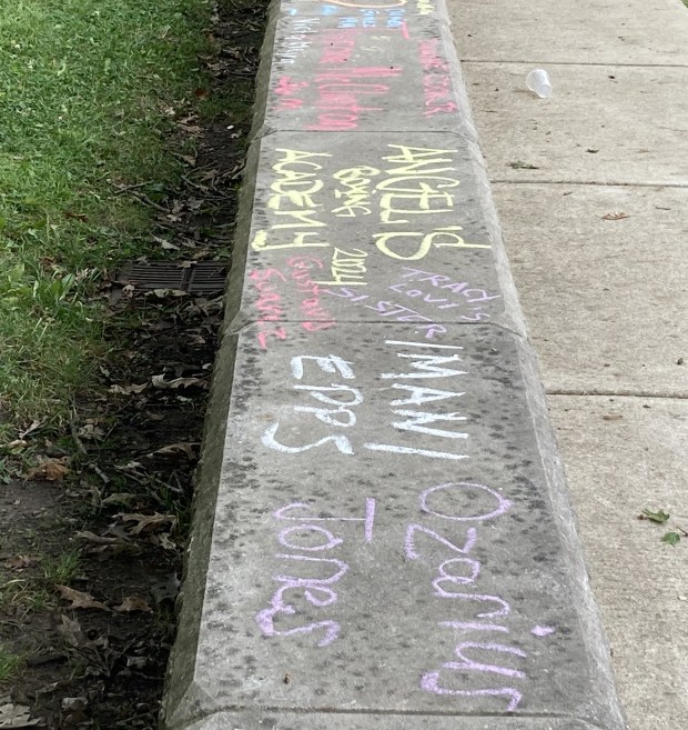 When cyclists and riders finished their journey at the second-annual Rock the Ride, there was chalk to write the name of a victim of gun violence. (Steve Sadin/For the Lake County News-Sun)