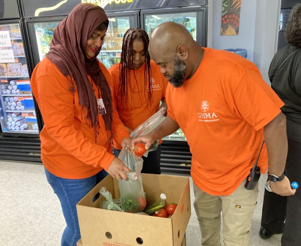 UMMA Executive Director Hamaas Ibrahim helps pack produce at the UMMA Harvest Market. (Steve Sadin/For the Lake County News-Sun)