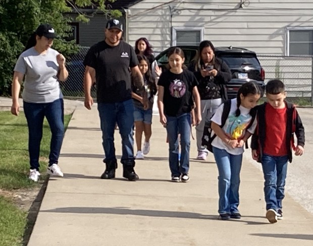 Parents walk their children to Washington Elementary School in Waukegan on the first day of class. (Steve Sadin/For the Lake County News-Sun)