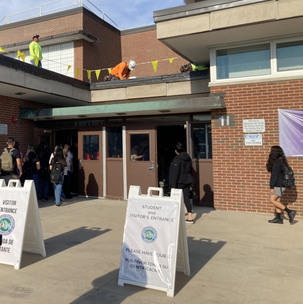 Waukegan High School students enter the Brookside campus on the first day of class Monday as workers continue completing a new roof. (Steve Sadin/For the Lake County News-Sun)