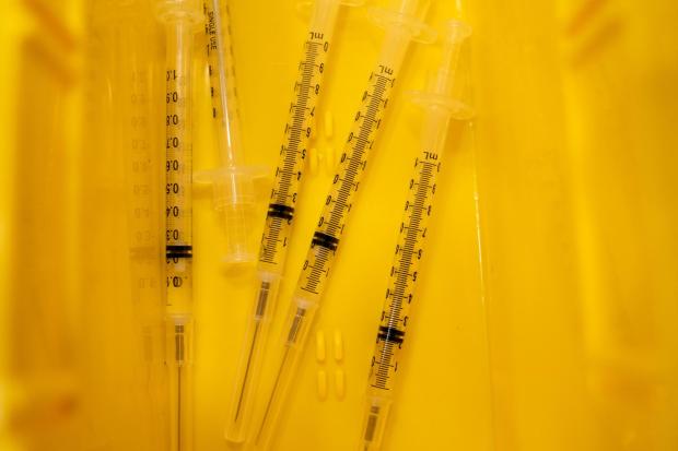 FILE Syringes filled with doses of the Pfizer/BioTech COVID-19 vaccine ready to administer in a clinic in Rochester Hills, Mich., on Jan. 19, 2021. A program that provided more than one million Covid shots to uninsured and underinsured people is coming to an end. (Emily Elconin/The New York Times)