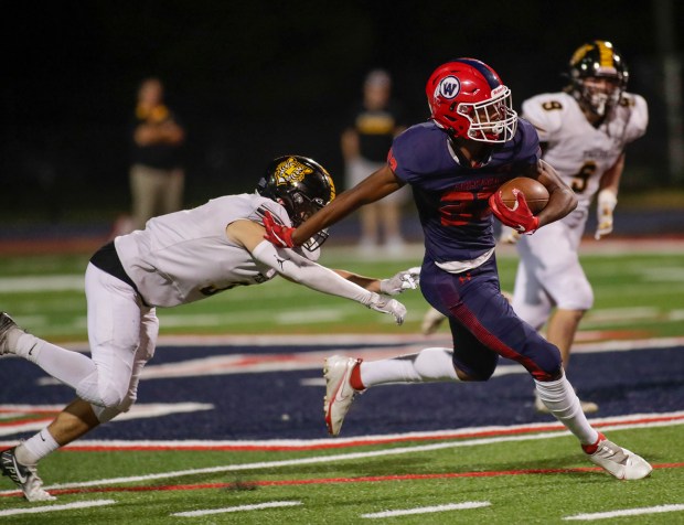 West Aurora's Terrence Smith, right, breaks free from Joliet West's Juan Rico, left, during a Southwest Prairie Conference game in Aurora on Thursday, Sept. 15, 2022.