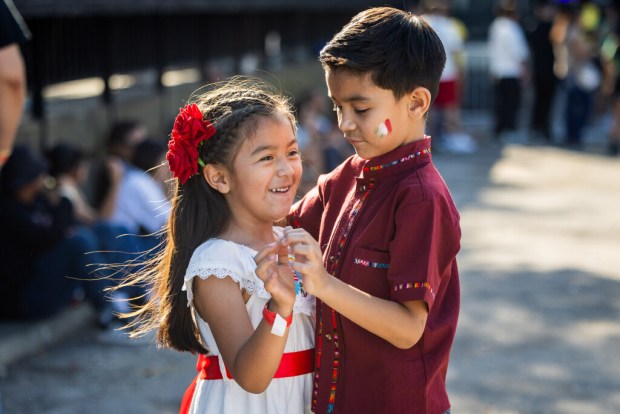 Paulette Sauceda, 5, and brother Javier Sauceda, 7, right, dance at El Grito Chicago, a two-day festival in celebration of Mexican Independence Day, at Grant Park's Butler Field in Chicago on Sept. 14, 2024. (Tess Crowley/Chicago Tribune)