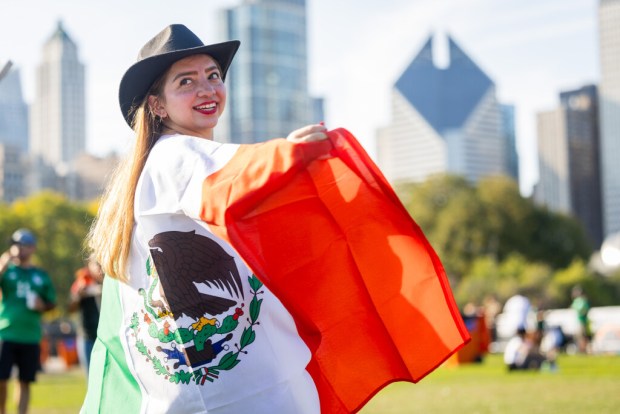 Alejandra Portillo looks back at a friend after posing for a photo at El Grito Chicago, a two-day festival in celebration of Mexican Independence Day, at Grant Park's Butler Field in Chicago on Sept. 14, 2024. (Tess Crowley/Chicago Tribune)