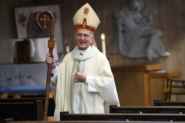 Bishop emeritus Dale Melczek prepares himself for Maundy Thursday mass at St. Mary of the Lake church in Gary on Thursday, March 29, 2018. (Kyle Telechan/Post Tribune)