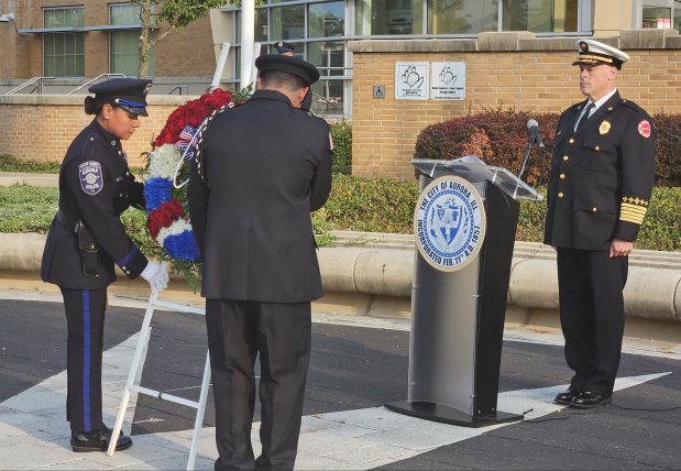 A wreath-laying ceremony is conducted during the remembrance event in Aurora Wednesday to honor those who lost their lives during the terrorist attacks on the United States on Sept.11, 2001. (David Sharos / For The Beacon-News)