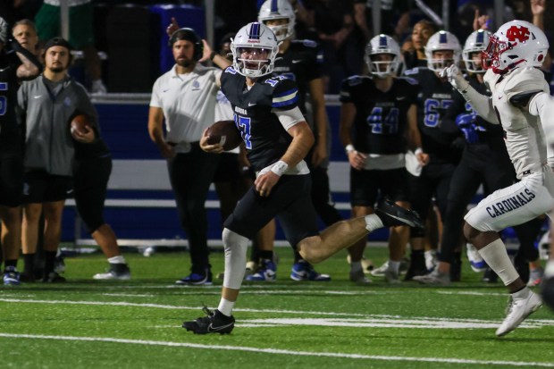 Aurora University's Tyler Adkins (17) runs the ball against North Central College during a game in Aurora on Saturday, Sept. 14, 2024. (Troy Stolt / The Beacon-News)