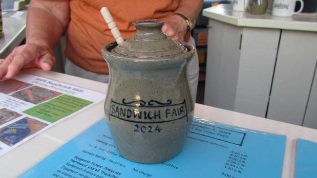 A honey pot with lid and dipper, made by Rowe Pottery, was one of the souvenirs available this year at the Sandwich Fair. (Linda Girardi / For The Beacon-News)