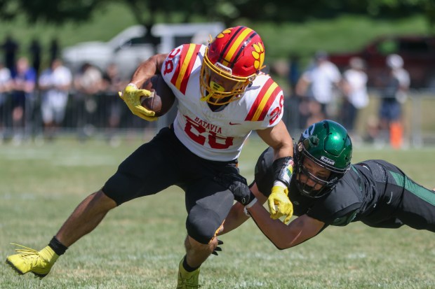 Batavia's Nathan Whitwell (28) runs the ball against Glenbard West during a nonconference game in Glen Ellyn on Saturday, Aug. 31, 2024. (Troy Stolt / The Beacon News)