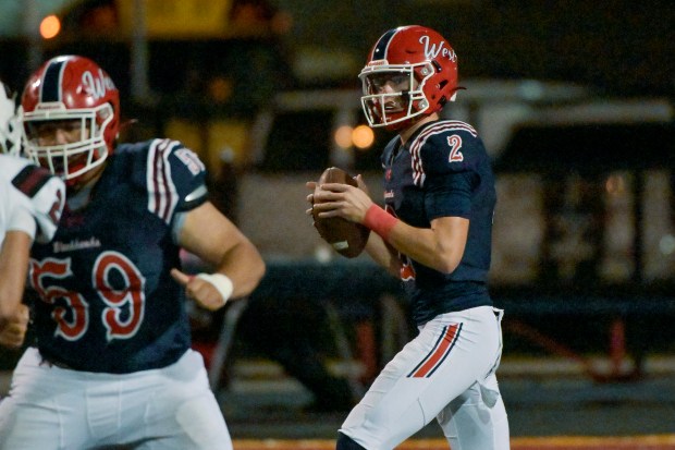 West Aurora's Mason Atkins (2) looks for an open receiver against Elgin in Aurora on Friday, Sept. 13, 2024. (Mark Black / The Beacon-News)