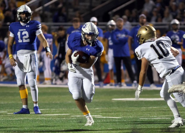 Geneva's Michael Rumoro, left, runs the ball against Lemont during the football game in Geneva on Friday, Sept. 6, 2024. (James C. Svehla / Beacon News)