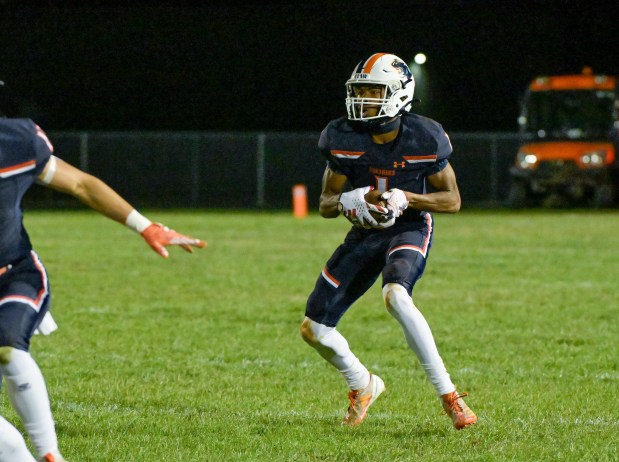 Oswego's Jeremiah Cain (1) runs the ball against Plainfield North in Oswego on Friday, Sept. 27, 2024. (Mark Black / The Beacon-News)