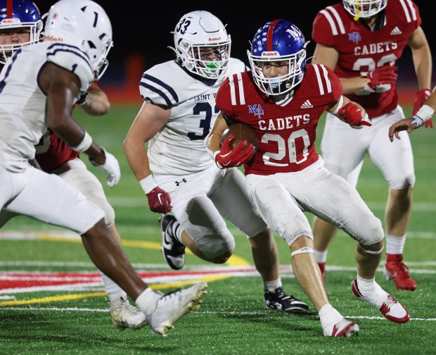 Marmion's Sean Dahlman (20) makes a cut up field in the first half as St. Viator's Dayvion Ellis (1) and Zach Mascolo (33) pursue during a non-conference game in Aurora on Friday, Sept. 13, 2024.(H. Rick Bamman / The Beacon News)