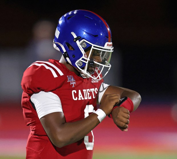 Marmion's Kam'ron Tolliver (3) checks his play list in the first half against St. Viator during a non-conference game in Aurora on Friday, Sept. 13, 2024.(H. Rick Bamman / The Beacon News)