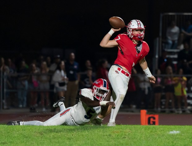 South Elgin quarterback John Ginnan, 7, is sacked by West Aurora's Temilade Dada during an Upstate Eight Conference game in South Elgin on Friday, Sept. 20, 2024. (Ryan Rayburn / for The Beacon News)